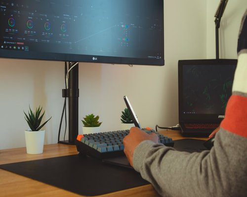 person adjusting posture while sitting at a minimalist desk